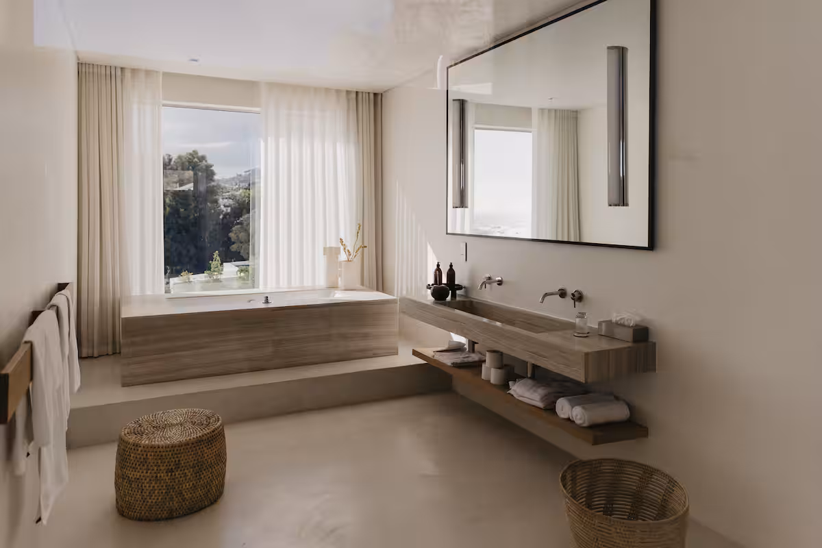 A bathroom with the bath set into the window and a double vanity along the wall